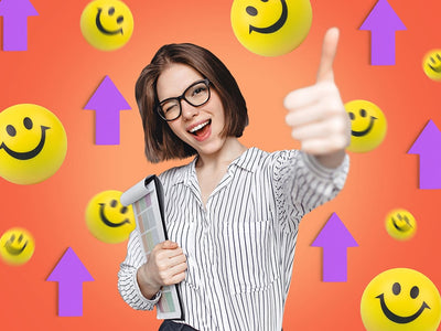 A girl in glasses holds a notepad and gives a thumbs up with a smiley face and purple