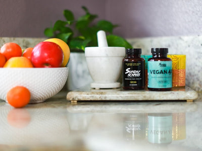 Sunday Scaries products on a kitchen counter next to a bowl of fruit showing that CBD does not make you hungry