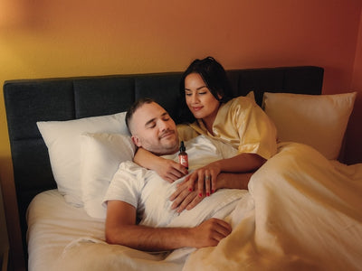 A wife gives her husband a sleep oil showing how CBD makes you tired