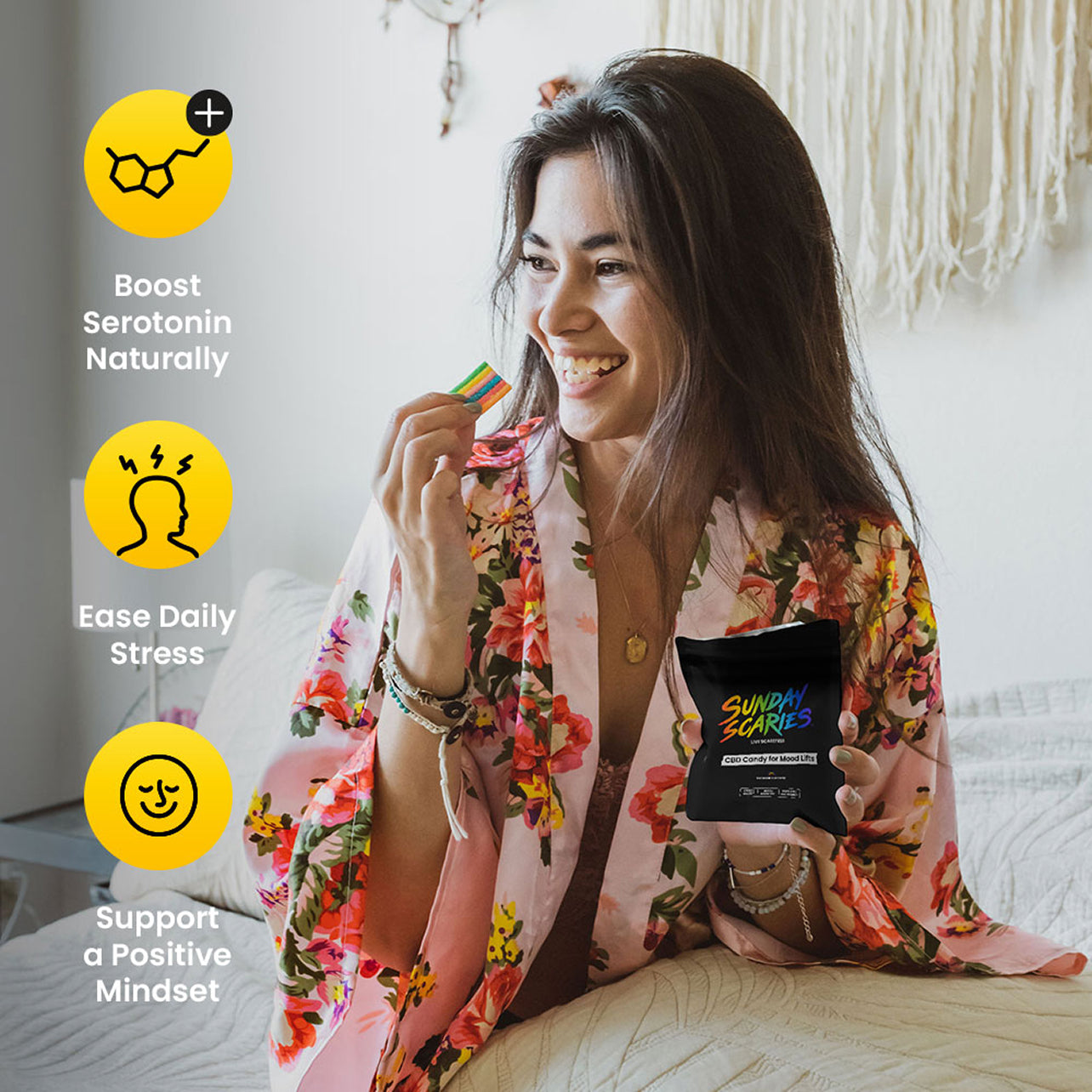 Woman in a floral robe holding a pouch of Sunday Scaries CBD candy with text about boosting serotonin, easing stress, and supporting a positive mindset.