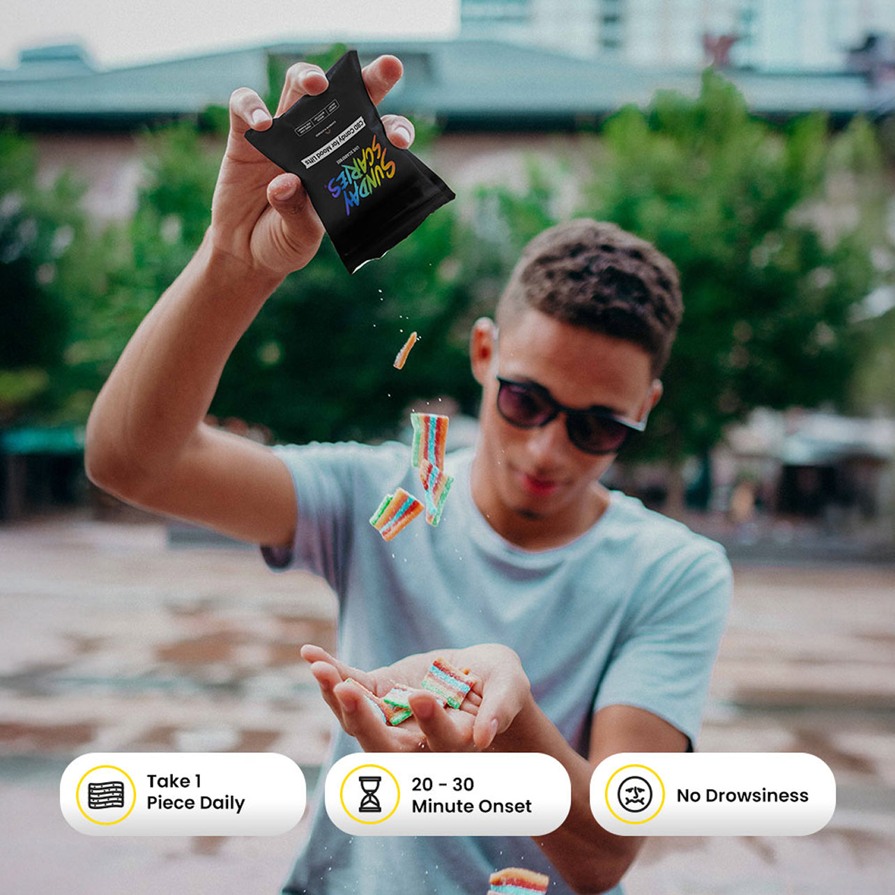 Person outdoors holding a CBD candy pouch and colorful candies pour out with product call out icons.