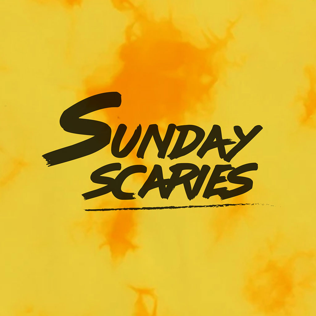 A close up image of the Sunday Scaries logo on the yellow tie-dye Sunday Scaries hooded sweatshirt
