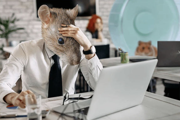 A young professional is stressed at his office desk and has the head of a rat because he's trying to escape the rat race - Sunday Scaries