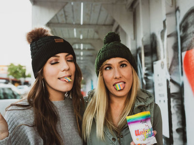 Two girls embrace self-expression by making funny faces and eating Unicorn Jerky