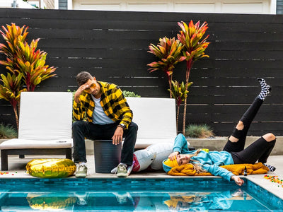 A man and woman are hungover by the pool
