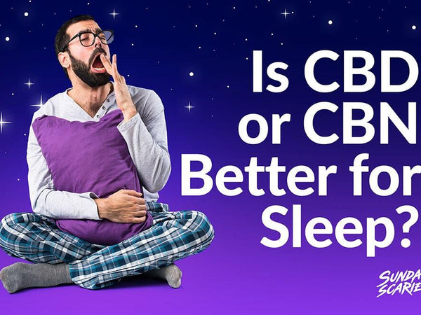 An image of a man holding a pillow and yawning while questioning whether CBD or CBN is better for sleep