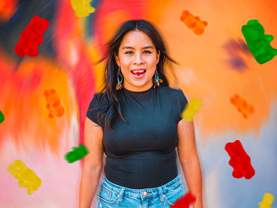 A female Sunday Scaries influencer with gummy bears flowing around her showing if CBD makes you high or not