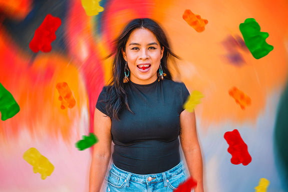 A female Sunday Scaries influencer with gummy bears flowing around her showing if CBD makes you high or not