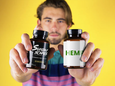 A man holds up two bottles showing hemp gummies vs. CBD gummies and what the difference is