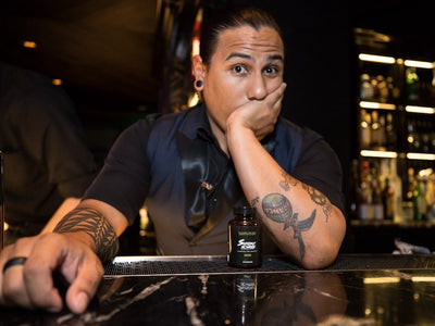 A bartender next to a bottle of Sunday Scaries questions how long THC from CBD gummies stays in your system
