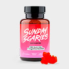 A bottle of Sunday Scaries CBD Gummies for Focus with a couple of pink gummy candies in the foreground.