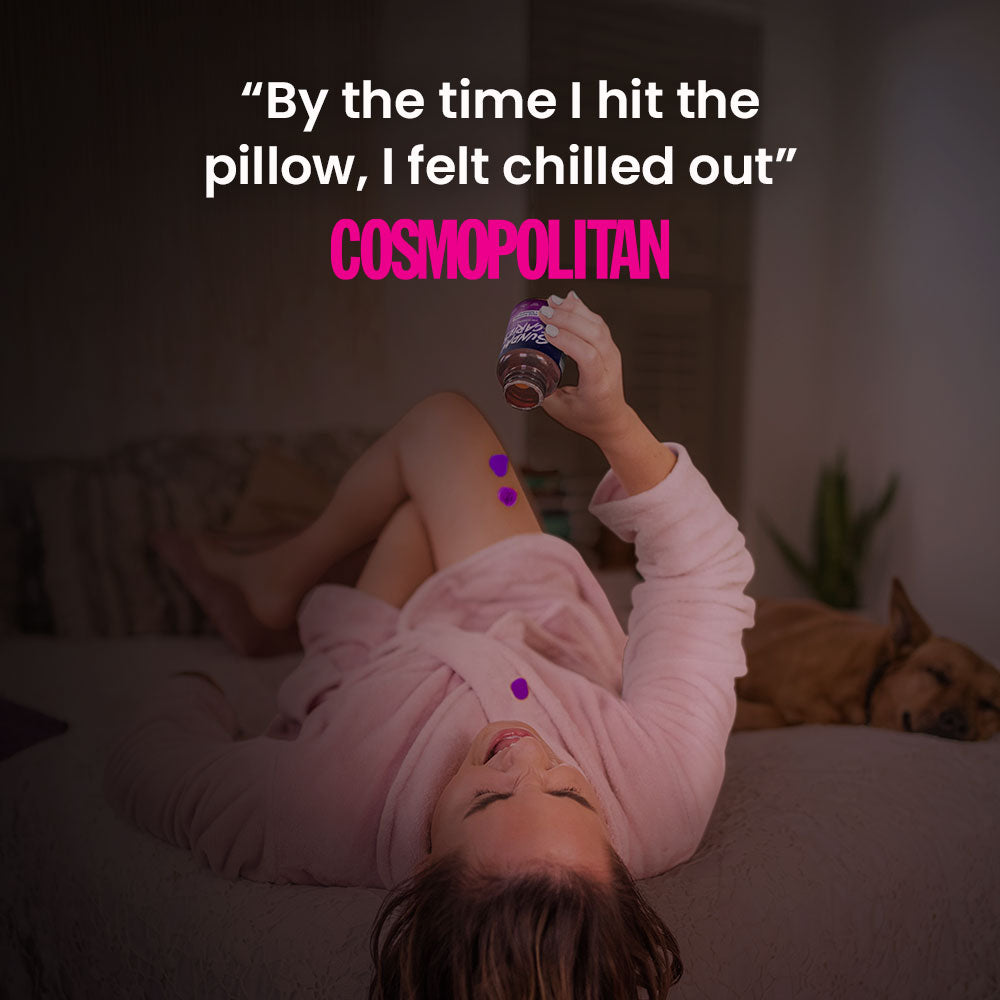 A woman in a robe lays back on her bed and pours THC sleep gummies in her mouth with a quote from Cosmopolitan that reads "By the time I hit the pillow, I felt chilled out"