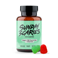 Bottle of Sunday Scaries Vegan CBD Gummies + Vitamins with two gummies on a white background