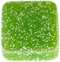 Green square vegan gummy with a sugary texture on a white background