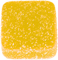 Yellow square vegan gummy with a sugary texture on a white background