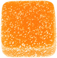Orange square vegan gummy with a sugary texture on a white background