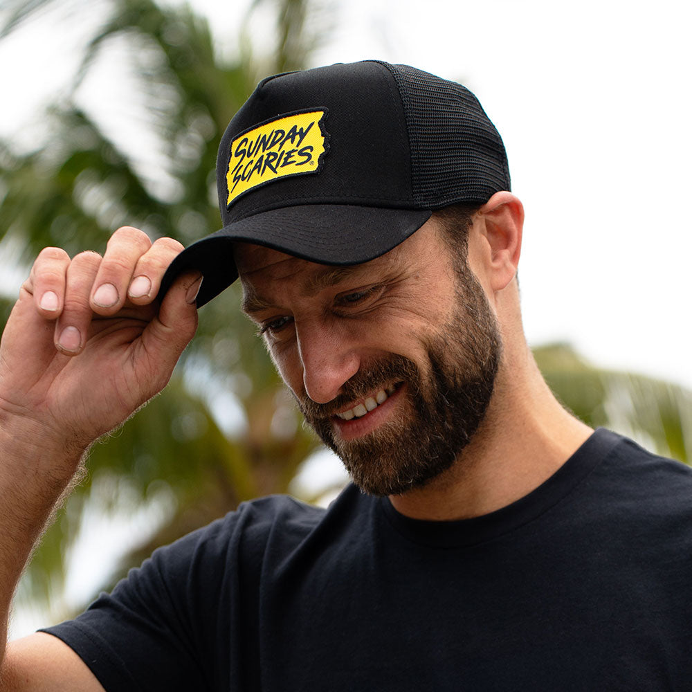 A male tips his Sunday Scaries hat