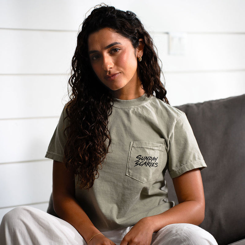 A female wears the unisex Sunday scaries pocket tee