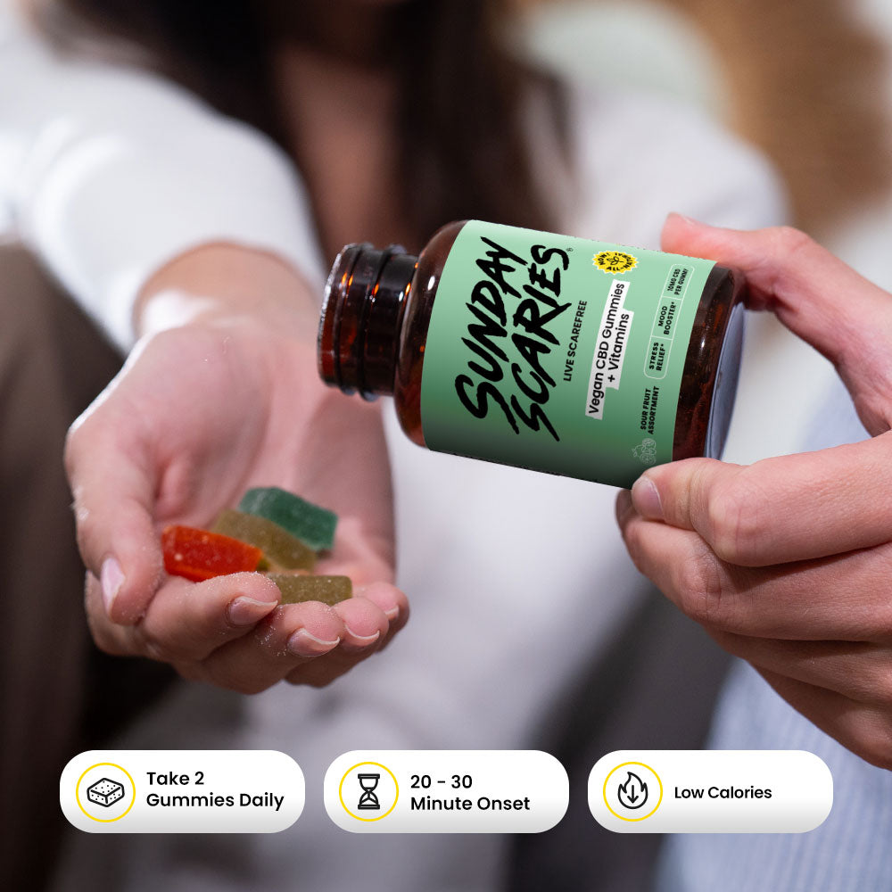 Person holding a bottle of Sunday Scaries vegan edition gummies with colorful gummies in their hand.