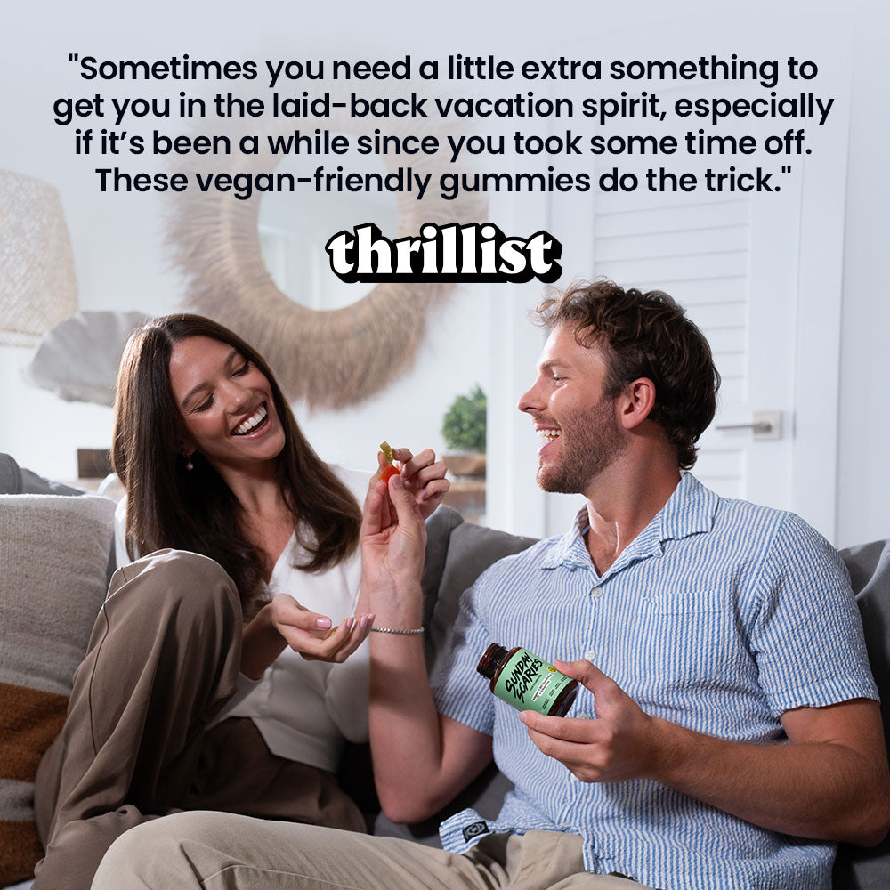 Man and woman sitting on a couch, man holding a bottle of gummies with a qoute from Thrillist that says "Sometimes you need a little extra something to get you in the laid-back vacation spirit, especially if it's been a while since you took some time off. These vegan-friendly gummies do the trick."